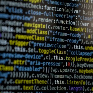 An extreme close-up of colorful programming code on a computer screen, showcasing development and software debugging.